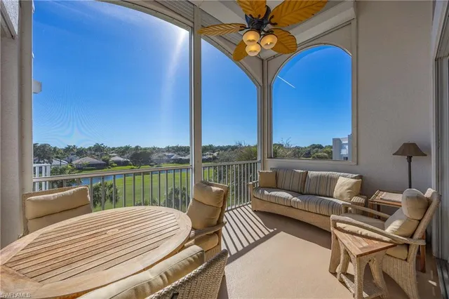 a balcony with furniture and a floor to ceiling window