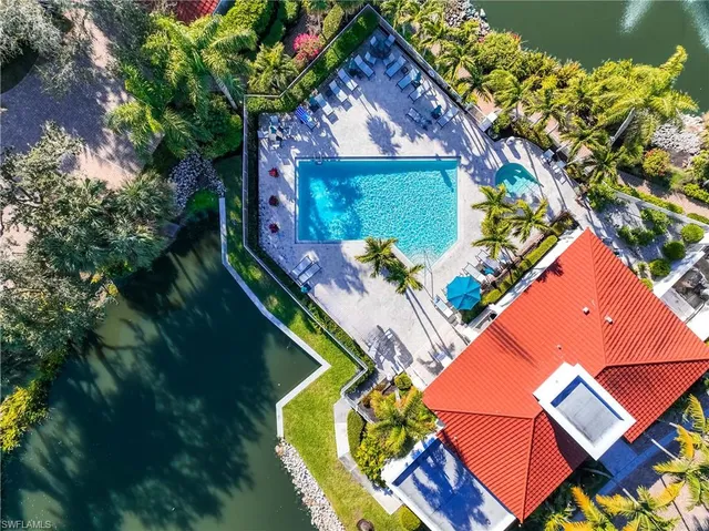 an aerial view of a house a yard and a fountain