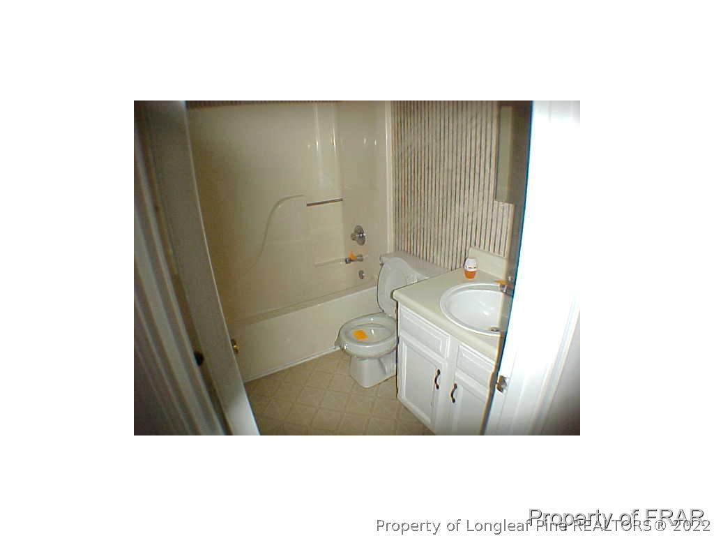 4546 Legion Road Hope Mills, NC 28348 - Photo 11 of 11 a bathroom with a sink a toilet and a shower