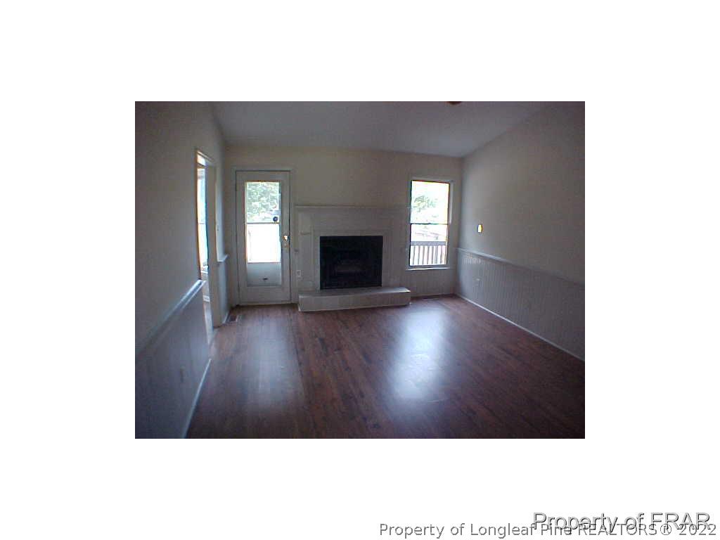 4546 Legion Road Hope Mills, NC 28348 - Photo 3 of 11 a view of an empty room with wooden floor and a window