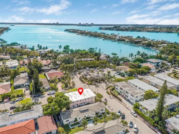 an aerial view of lake and residential houses with outdoor space
