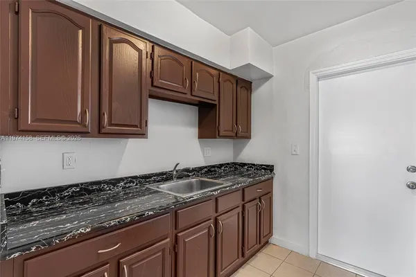 a kitchen with granite countertop cabinets and white appliances