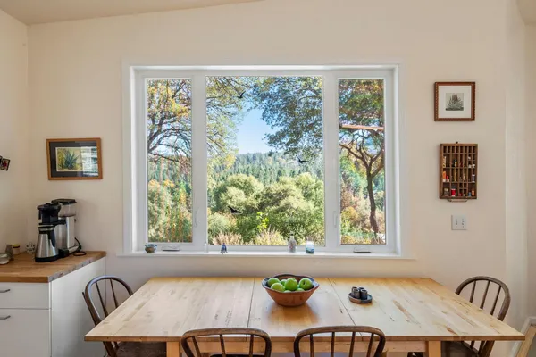 a large kitchen with a stove a sink dishwasher and white cabinets with wooden floor