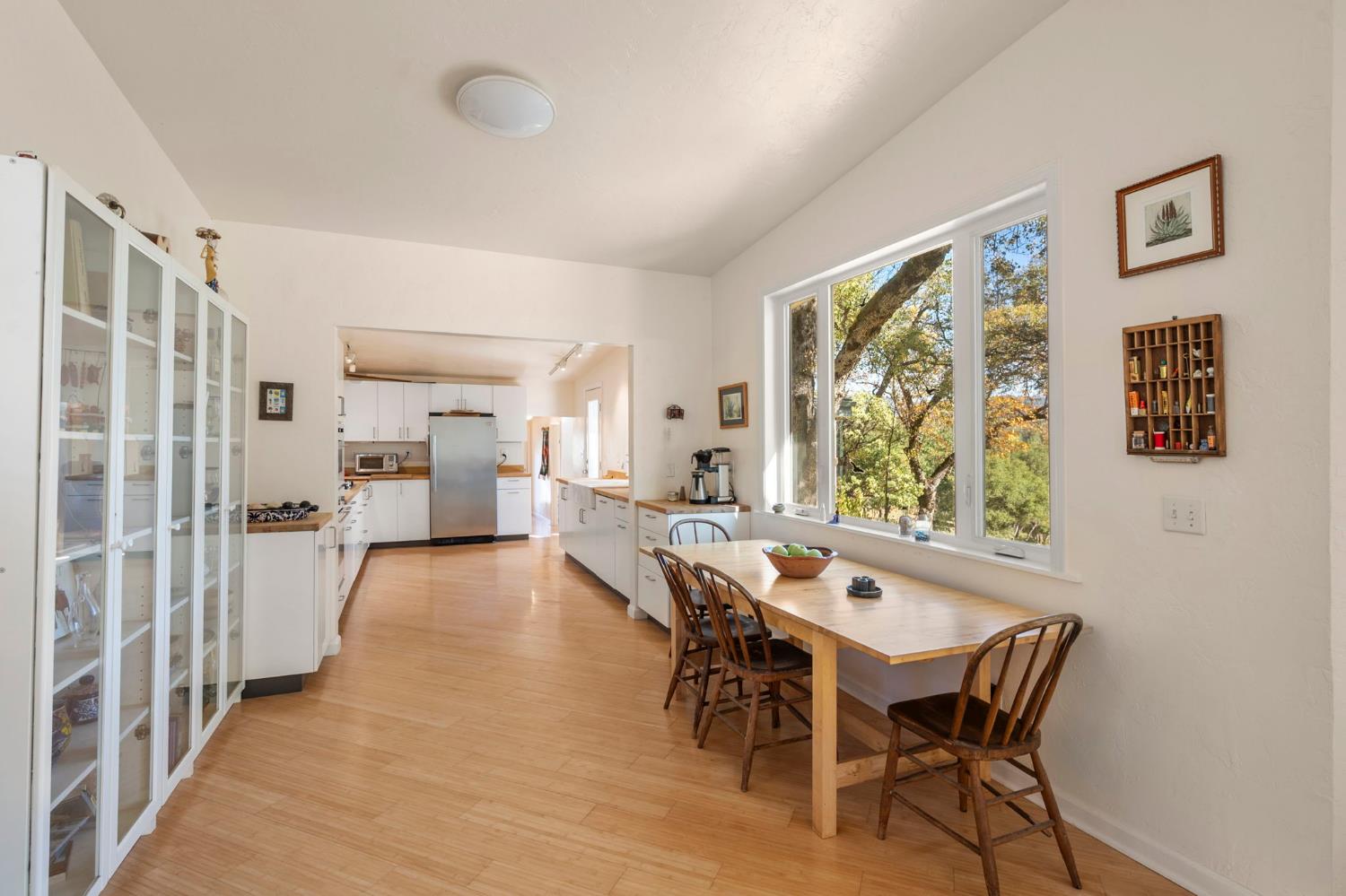 7123 Swiss Ranch Road Mountain Ranch, CA 95246 - Photo 19 of 66 a view of a dining room with furniture and a large window