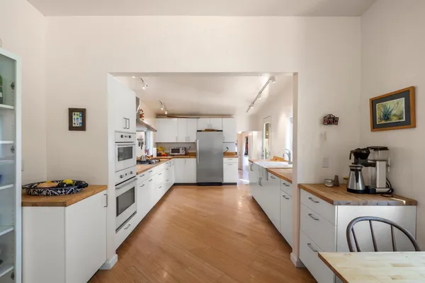 a kitchen with stainless steel appliances a refrigerator sink and cabinets