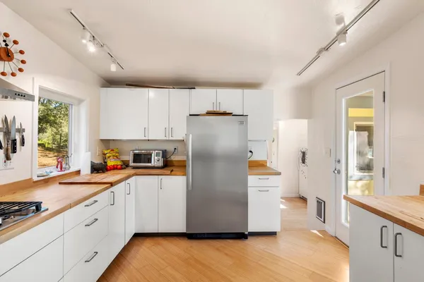 a bedroom with a bed and a mirror on the dresser