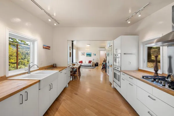 a walk in closet with clothes and shoes