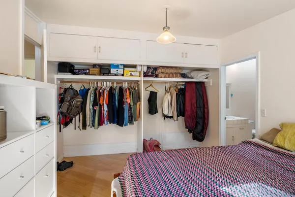 a spacious bedroom with a bed and a couch