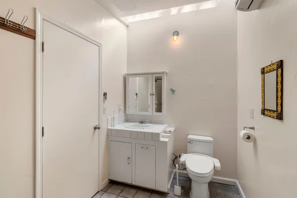 a bedroom with a bed and a mirror