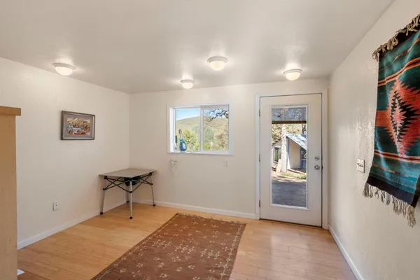 a living room with furniture and a dining table with chairs