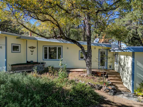 a view of a wooden deck and a backyard