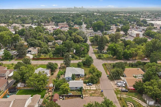 an aerial view of residential houses with outdoor space and river