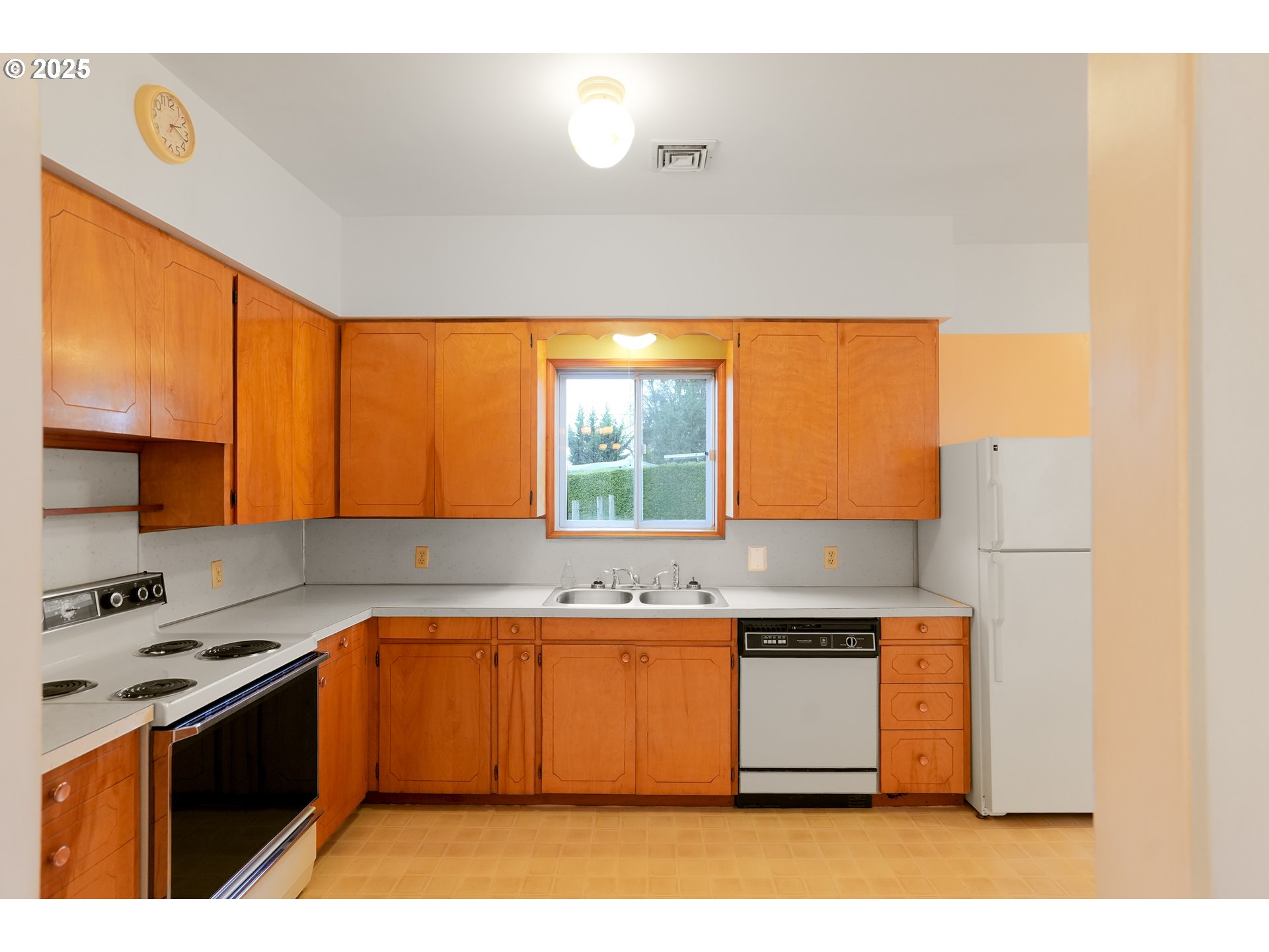 619 B Street Silverton, OR 97381 - Photo 18 of 42 a kitchen with a stove a sink and a refrigerator