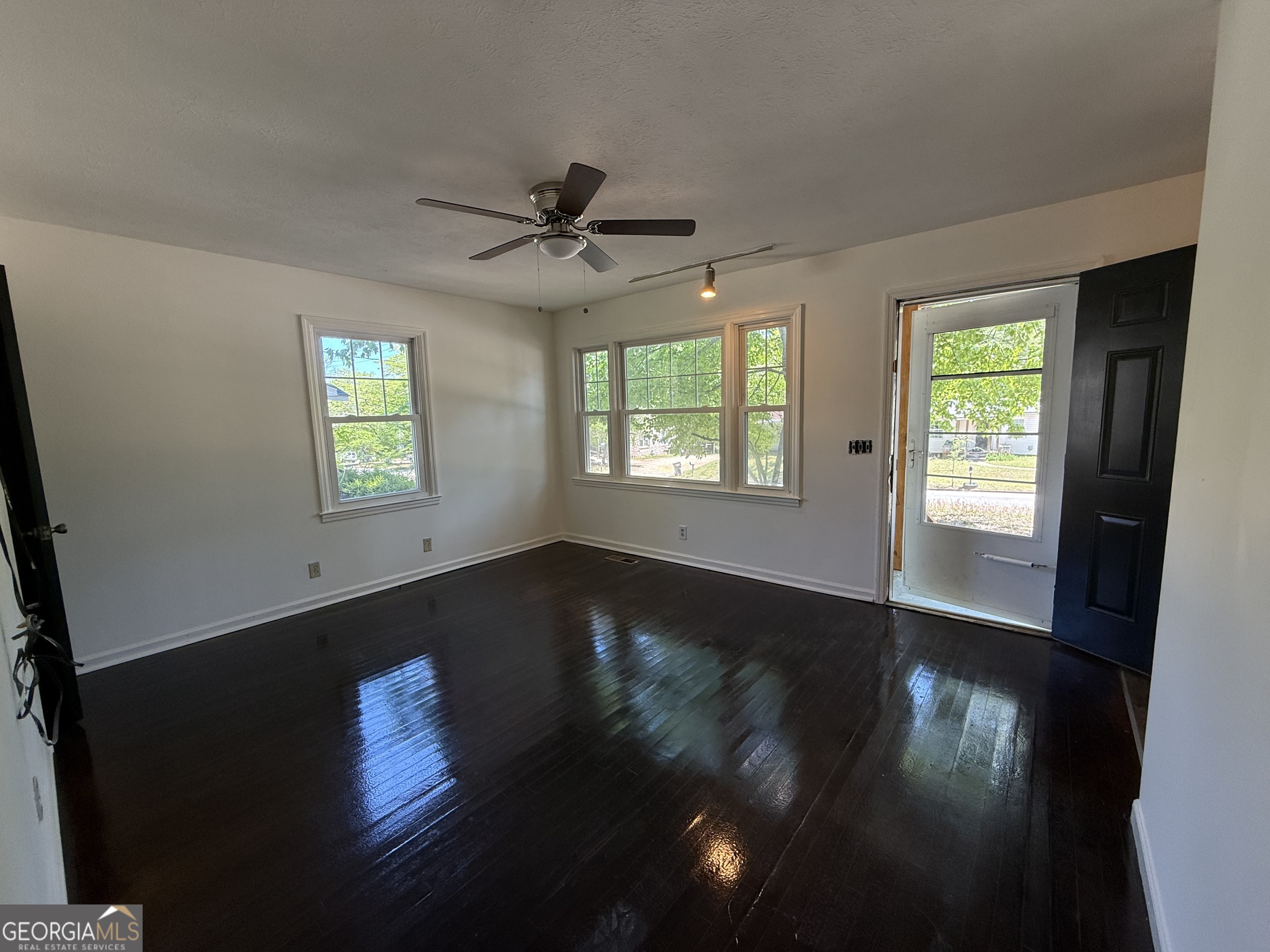 179 Youngs Mill Road LaGrange, GA 30241 - Photo 4 of 30 a view of an empty room with wooden floor and a window