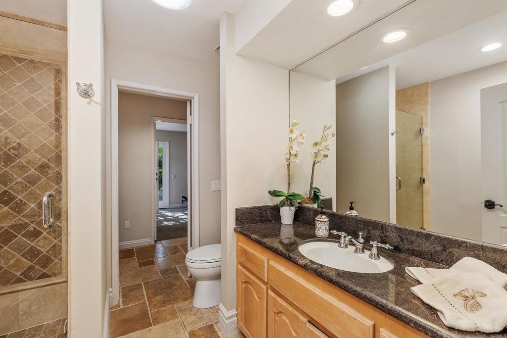 16346 Via Del Alba Rancho Santa Fe, CA 92067 - Photo 22 of 34 a bathroom with a granite countertop sink and a mirror