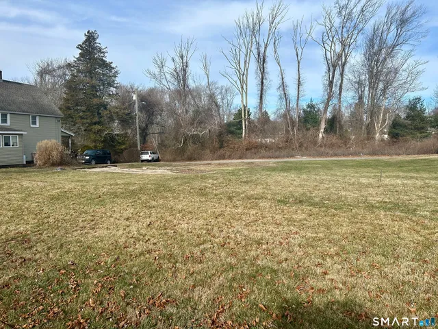 a view of a field with trees in the background