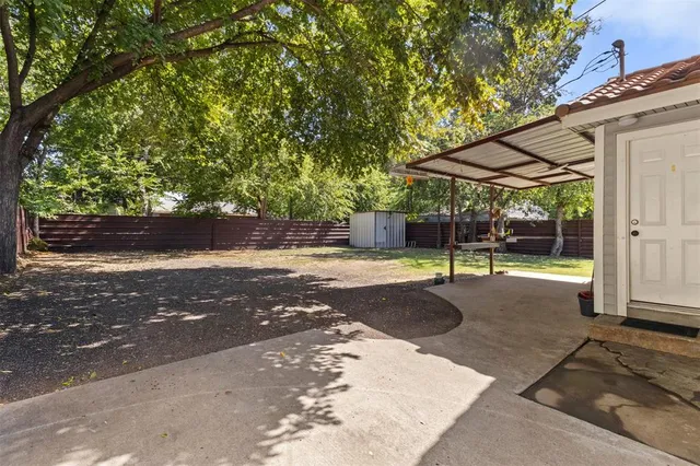 a backyard of a house with table and chairs