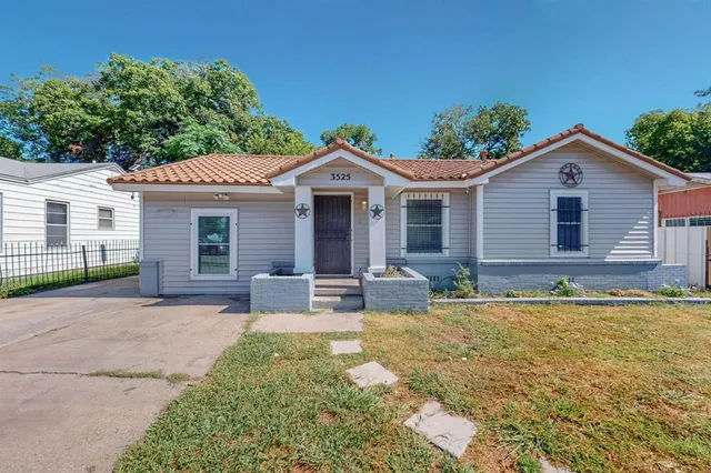a front view of a house with yard patio and glass windows