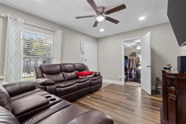 a living room with furniture and wooden floor