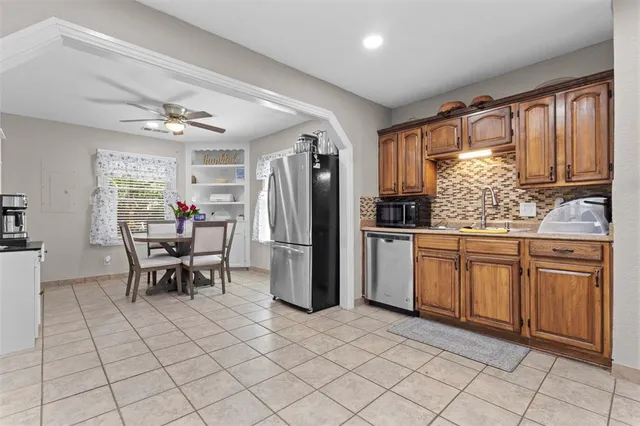 a kitchen with stainless steel appliances granite countertop a refrigerator and a sink
