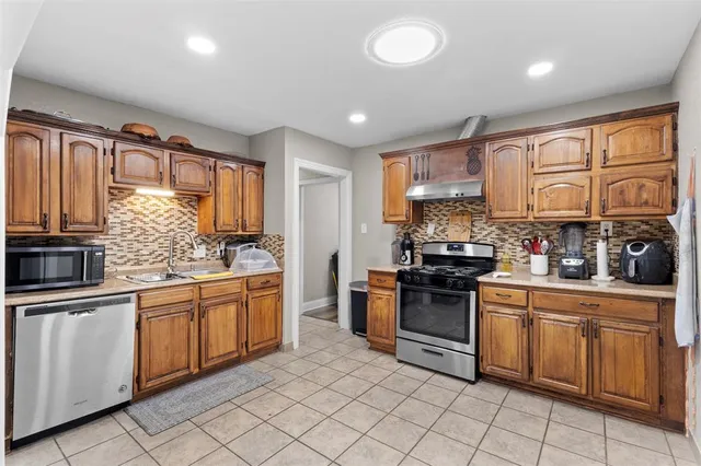 a kitchen with granite countertop appliances cabinets and furniture