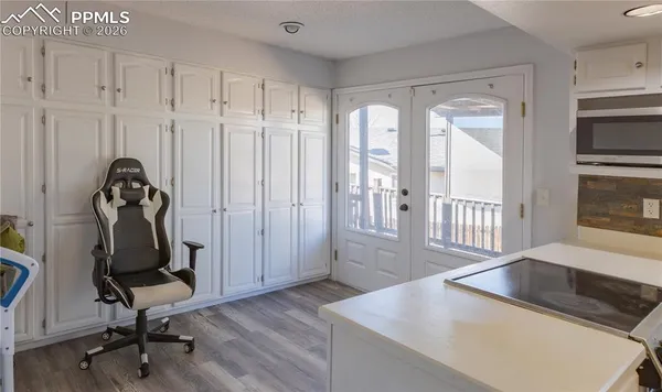 a kitchen with cabinets appliances a sink and a window