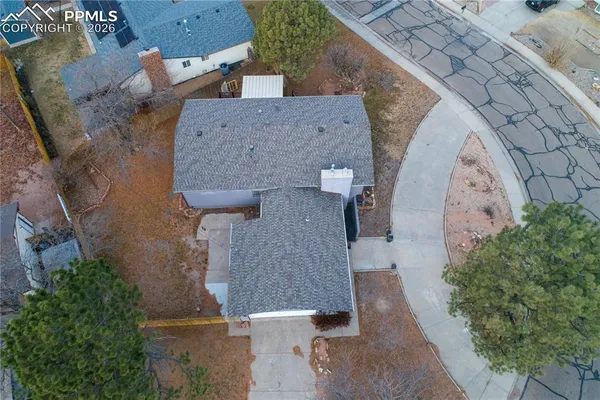 an aerial view of a house with a yard