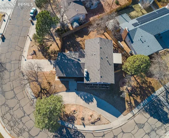 an aerial view of a house with a yard