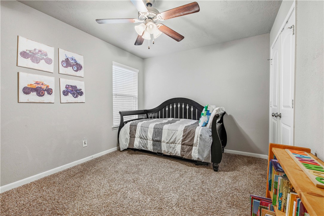 3014 Positano Loop Bryan, TX 77808 - Photo 17 of 23 a bed sitting in a bedroom next to a window