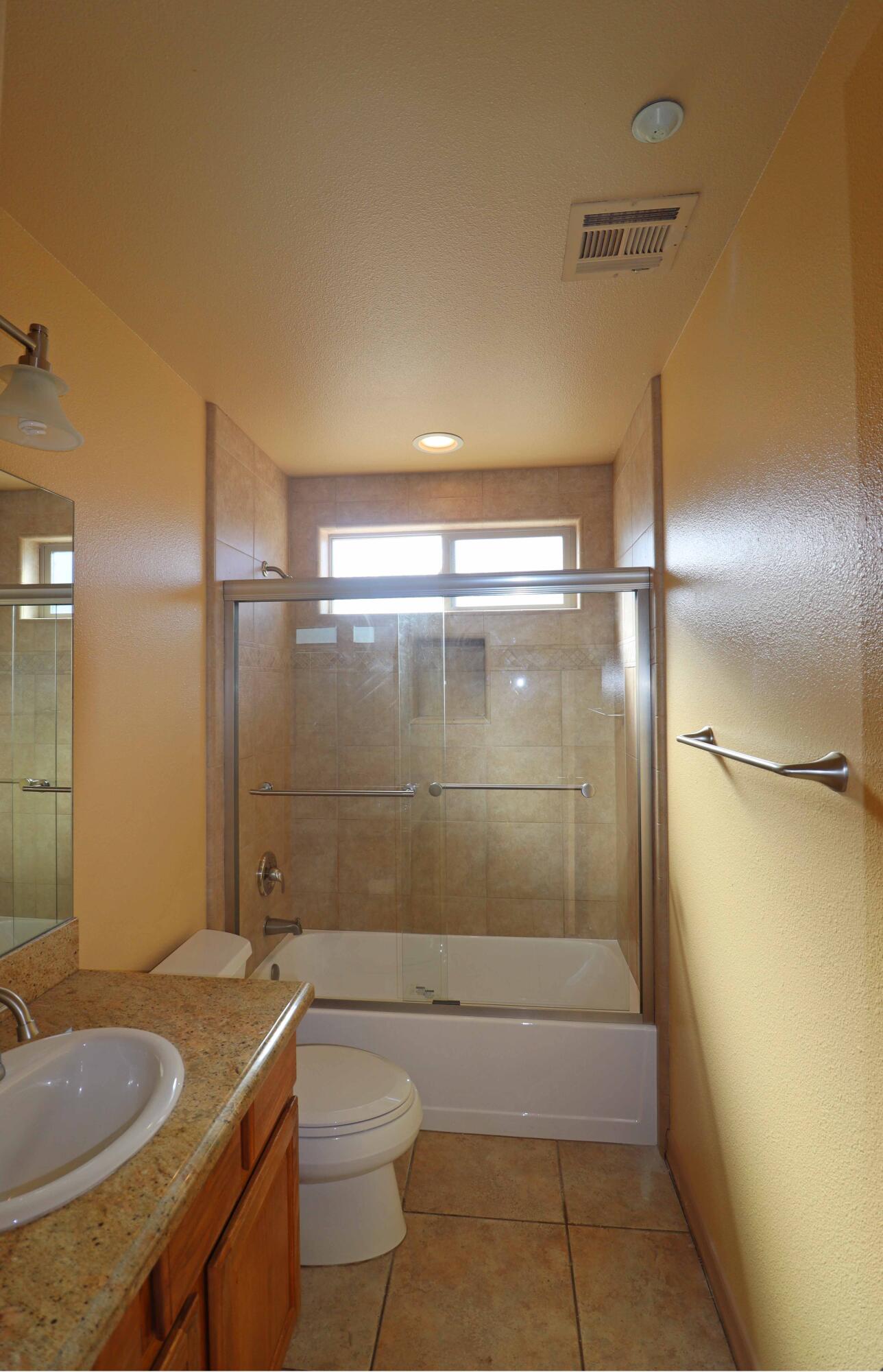 7201 Demesne Road Joshua Tree, CA 92252 - Photo 19 of 27 a bathroom with a granite countertop sink toilet and shower