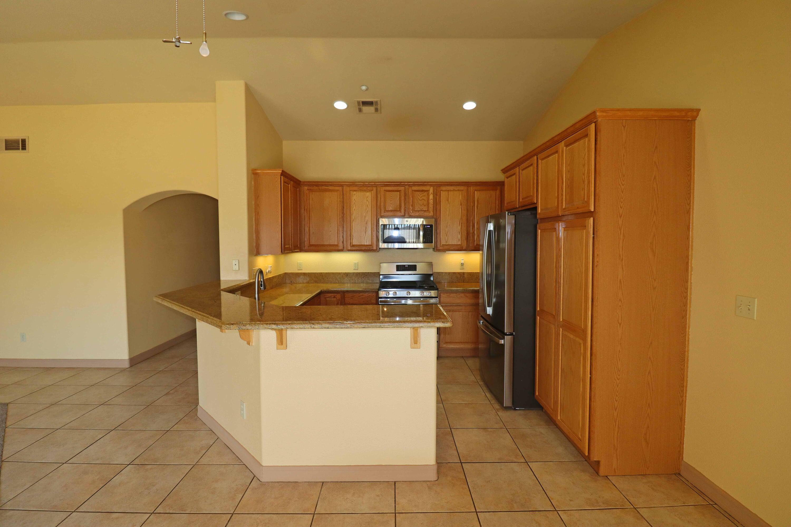7201 Demesne Road Joshua Tree, CA 92252 - Photo 8 of 27 a kitchen with a refrigerator and a stove