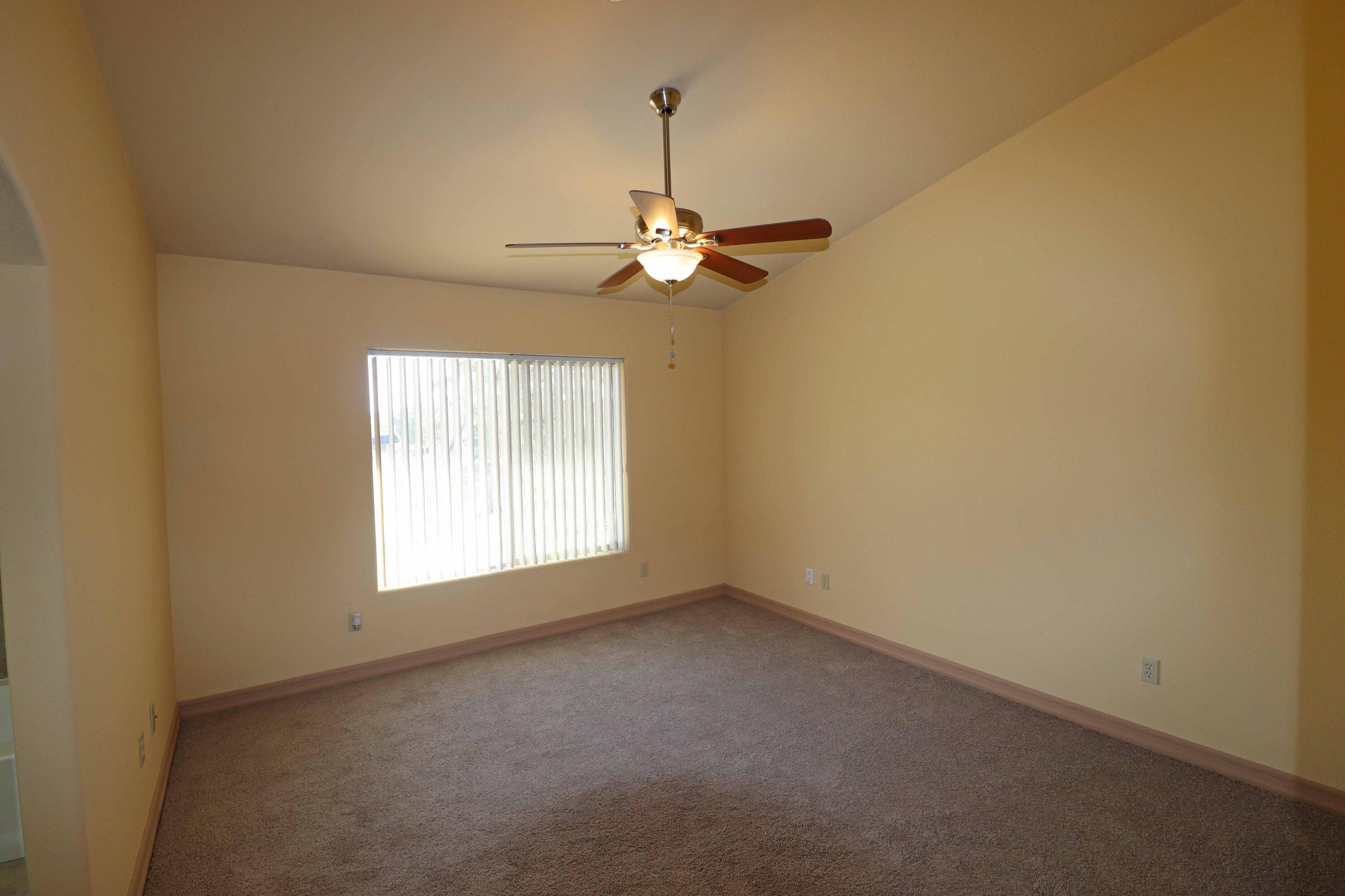 7201 Demesne Road Joshua Tree, CA 92252 - Photo 10 of 27 en empty room with windows and chandelier fan
