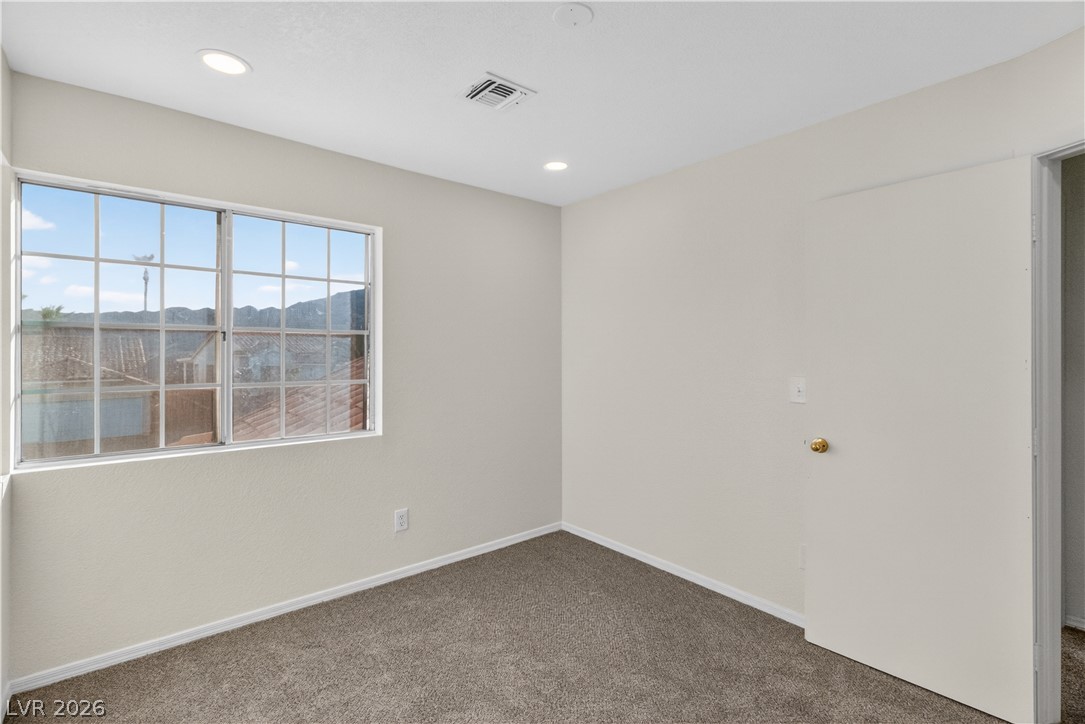 3156 Terrace View Drive Laughlin, NV 89029 - Photo 40 of 94 A quiet bedroom offers recessed lighting and plush carpet, creating a peaceful retreat.