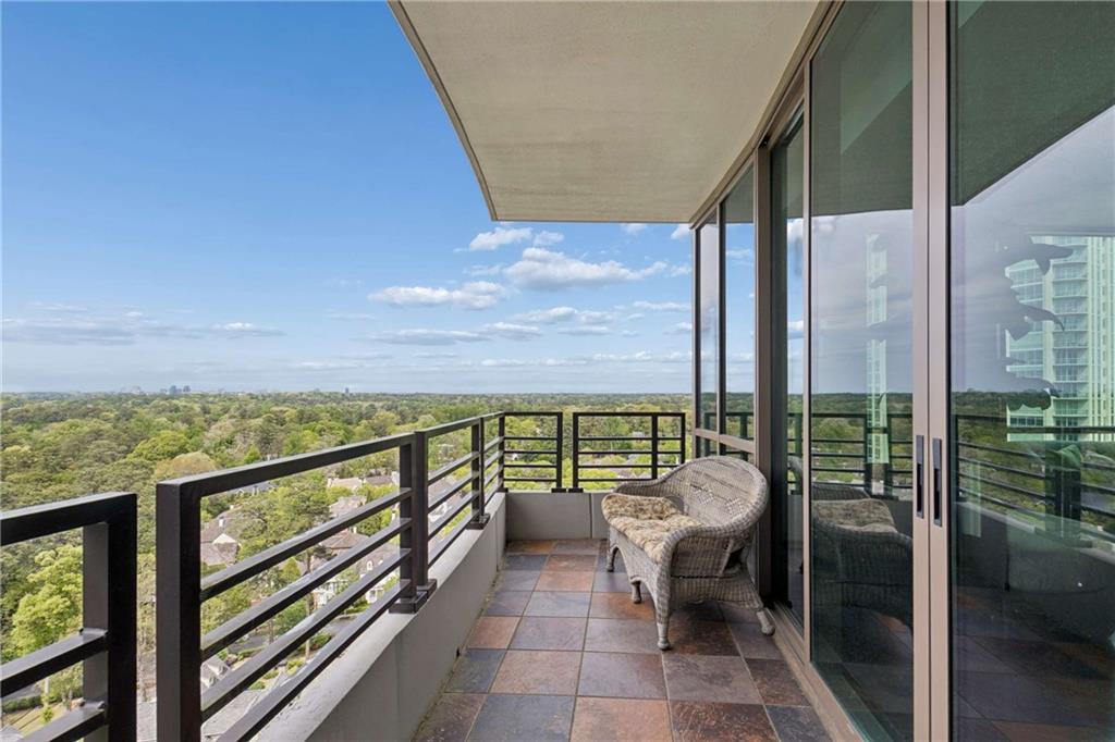 700 Park Regency Place Northeast, Unit 2002 Atlanta, GA 30326 - Photo 13 of 37 a balcony with furniture and city view