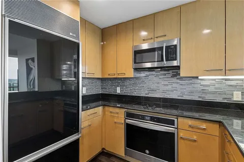 a kitchen with a sink and stainless steel appliances