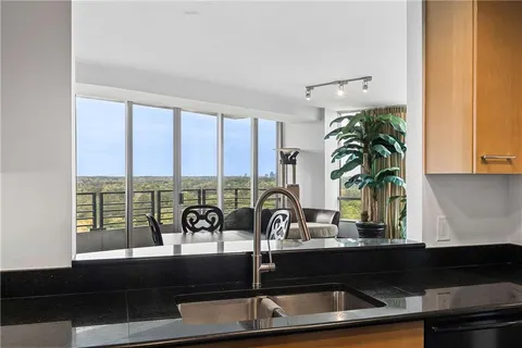 a kitchen with a large window and sink