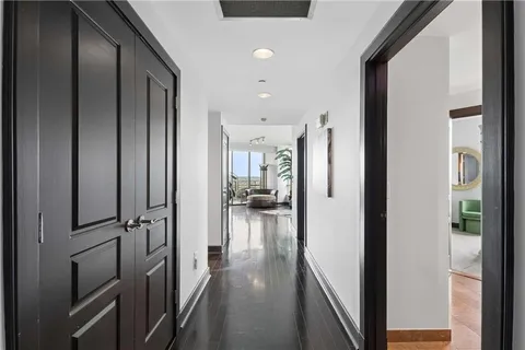 a view of a hallway with wooden floor and staircase