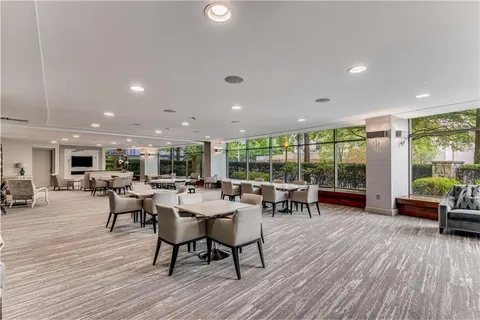 a dining room with furniture and wooden floor