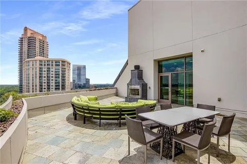 a swimming pool with outdoor seating yard and barbeque oven