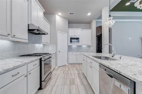 a view of kitchen with sink and cabinets
