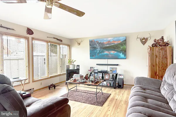 a living room with furniture and large windows