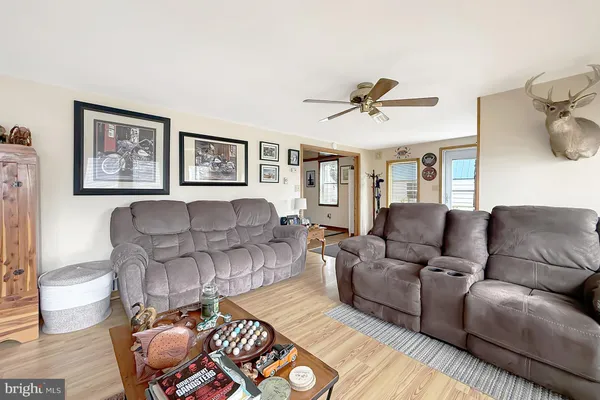 a living room with furniture and a painting on the wall