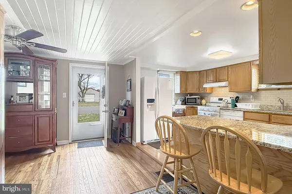 a kitchen with stainless steel appliances granite countertop a refrigerator and microwave