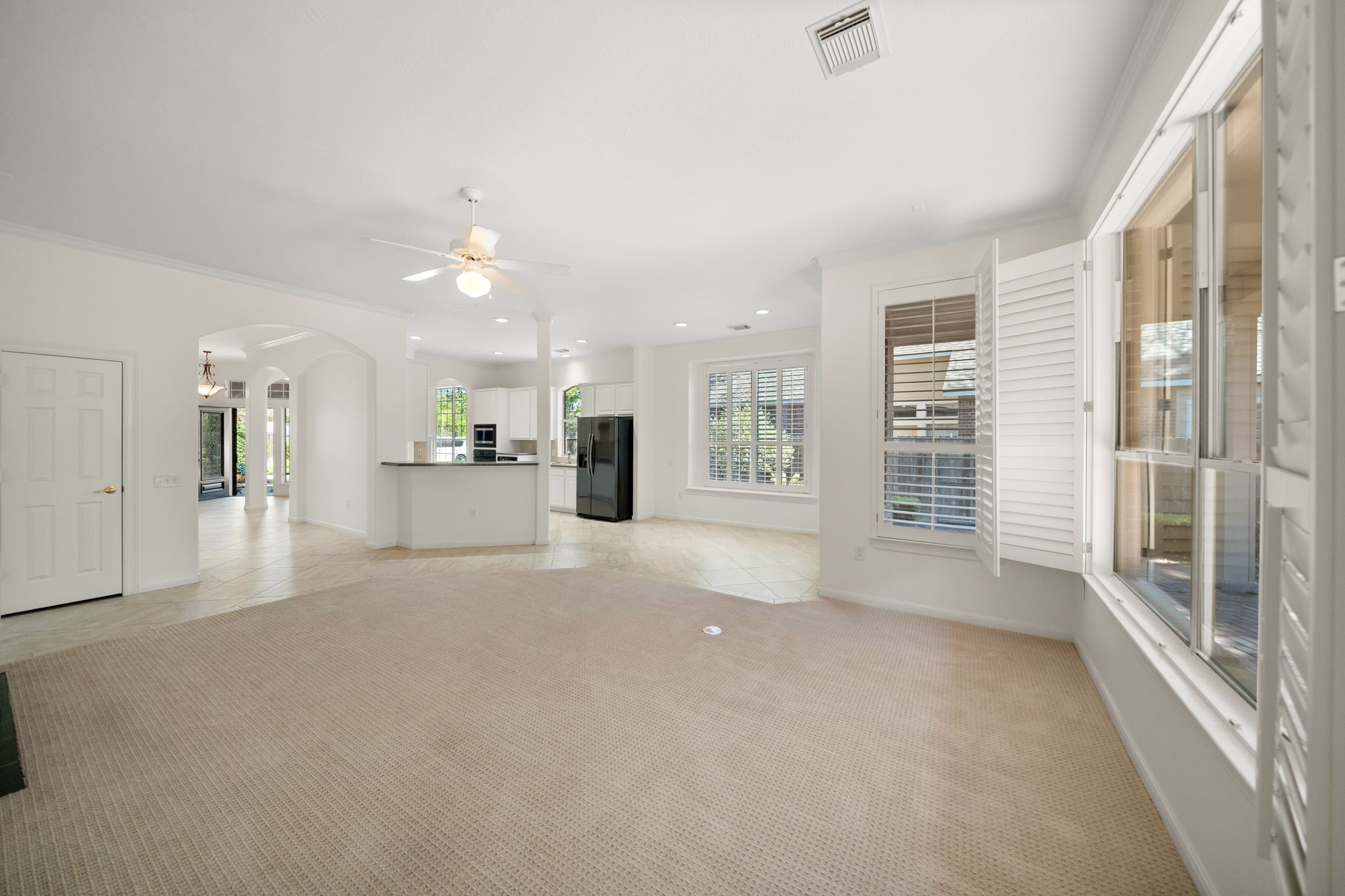 7 Sovereign Way Conroe, TX 77384 - Photo 10 of 31 a view of a livingroom with wooden floor and a kitchen