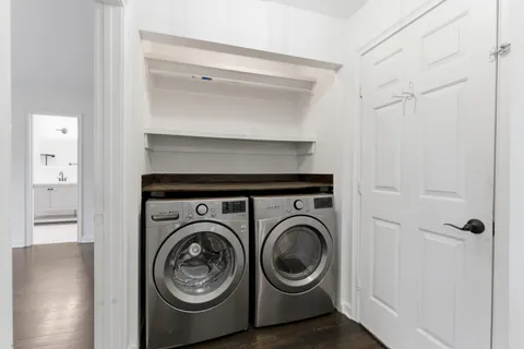 a view of storage and utility room with washer and dryer