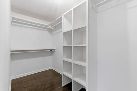 a view of walk in closet with empty racks