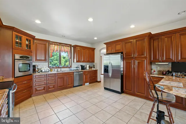 a view of a kitchen with dining area a sink and a refrigerator