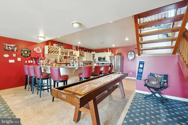 a living room with furniture and a dresser