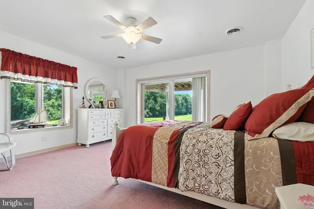 an empty room with a window and a ceiling fan