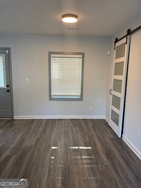 2899 Gresham Rd S East Atlanta, GA 30316 - Photo 12 of 17 an empty room with wooden floor and windows